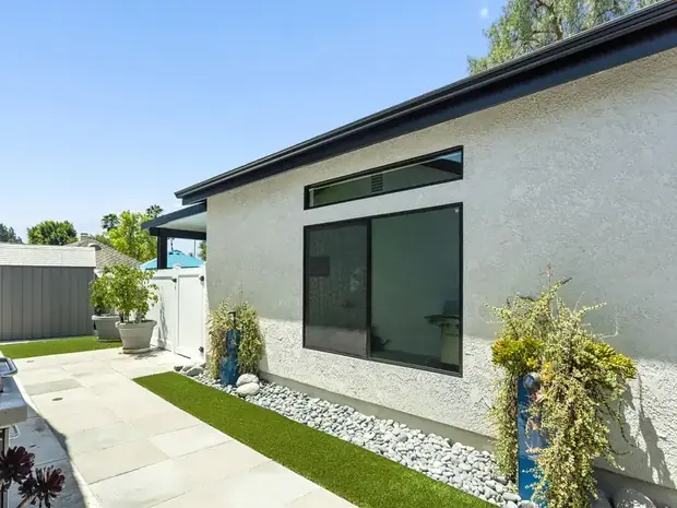 Daytime exterior of the same Thousand Oaks ADU with landscaping and a private path.