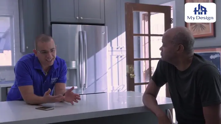 An H&A My Design team member talking with a homeowner in a finished kitchen.